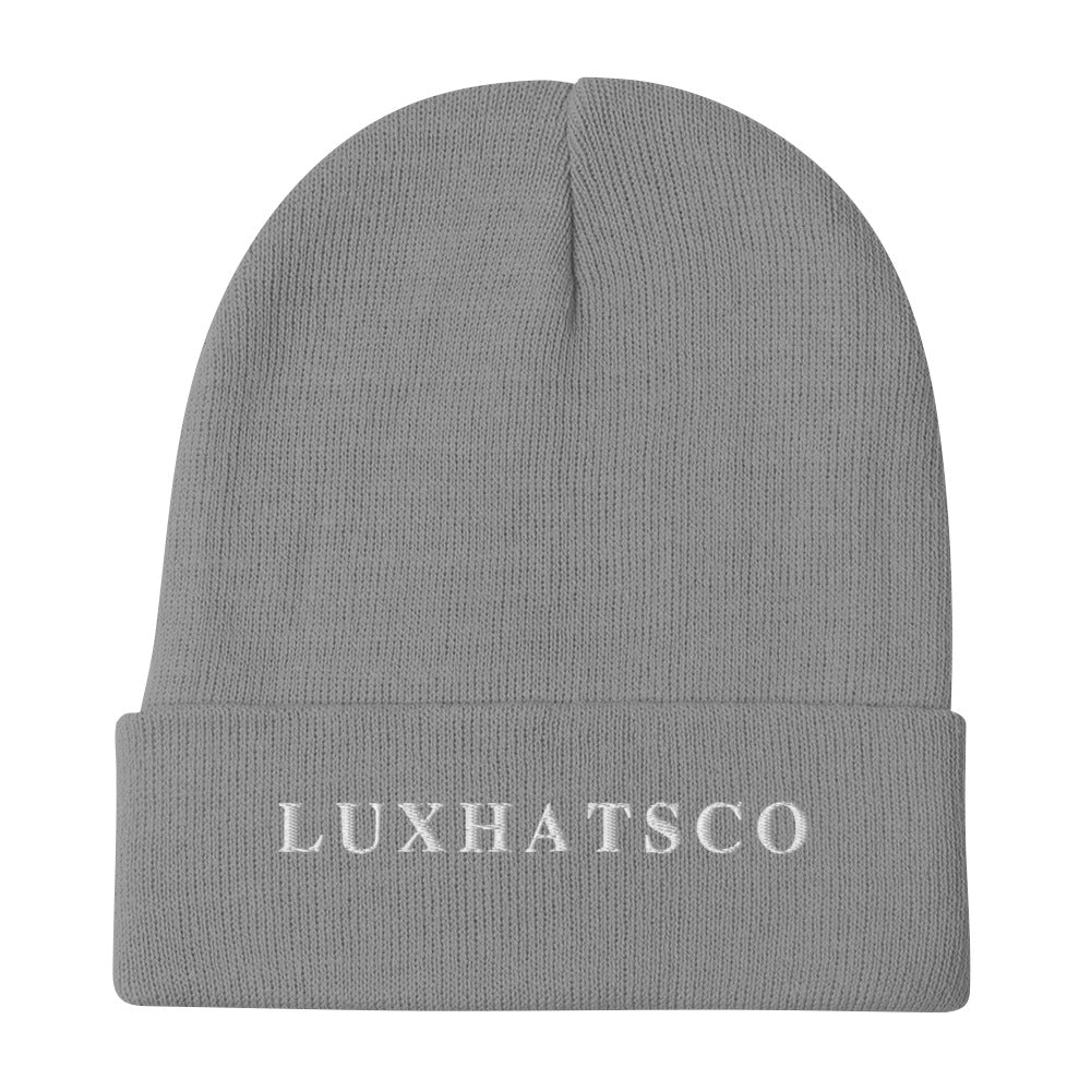 A gray beanie with the text 'LUXHATSCO' embroidered on the fold.
